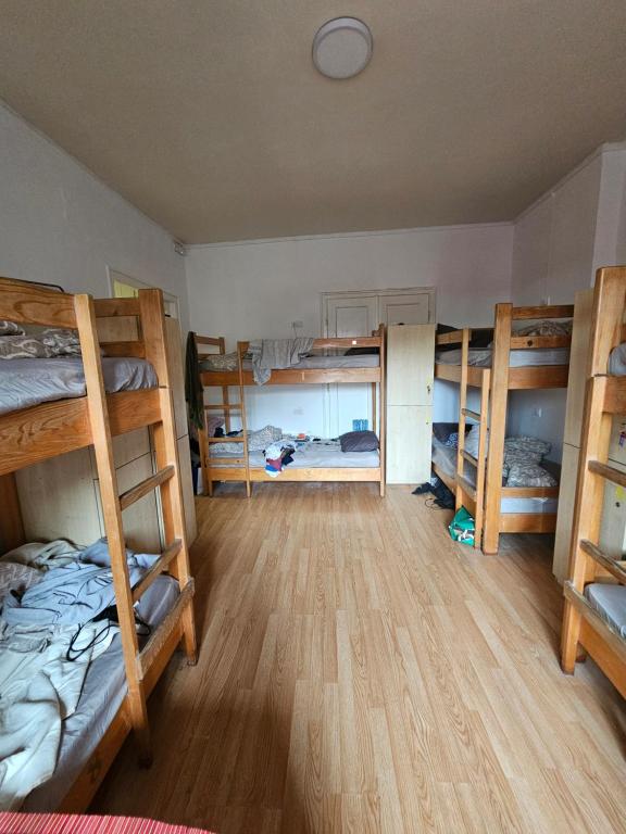 a room with four bunk beds in a room at The Traveling Theater in Belgrade