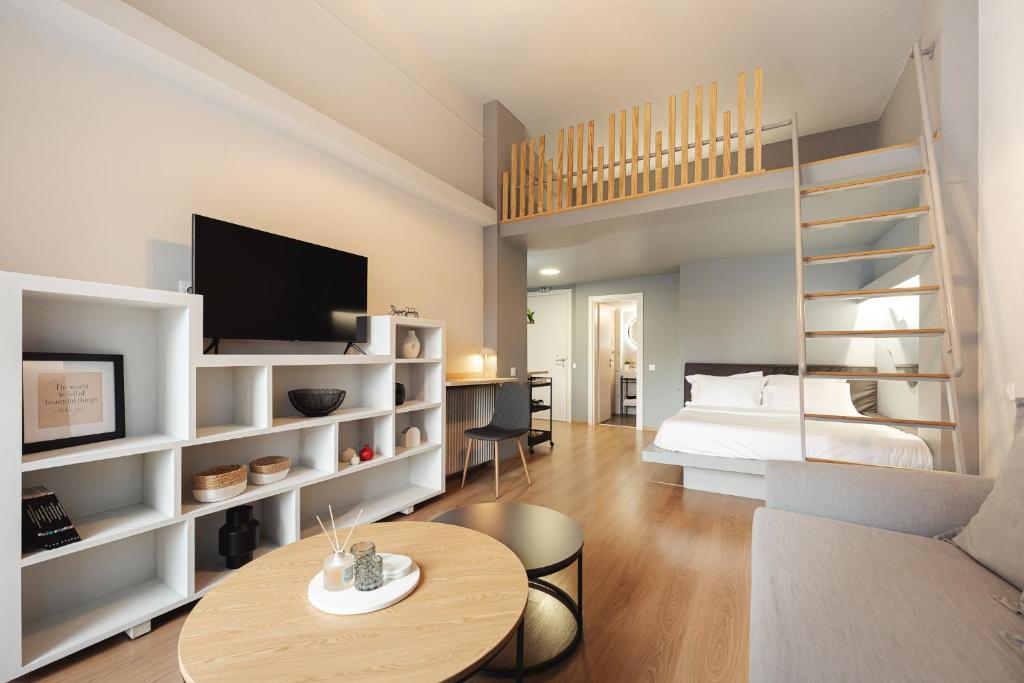 a bedroom with a bed and a loft bed with a desk at Aristotelous 22 Suites in Thessaloniki