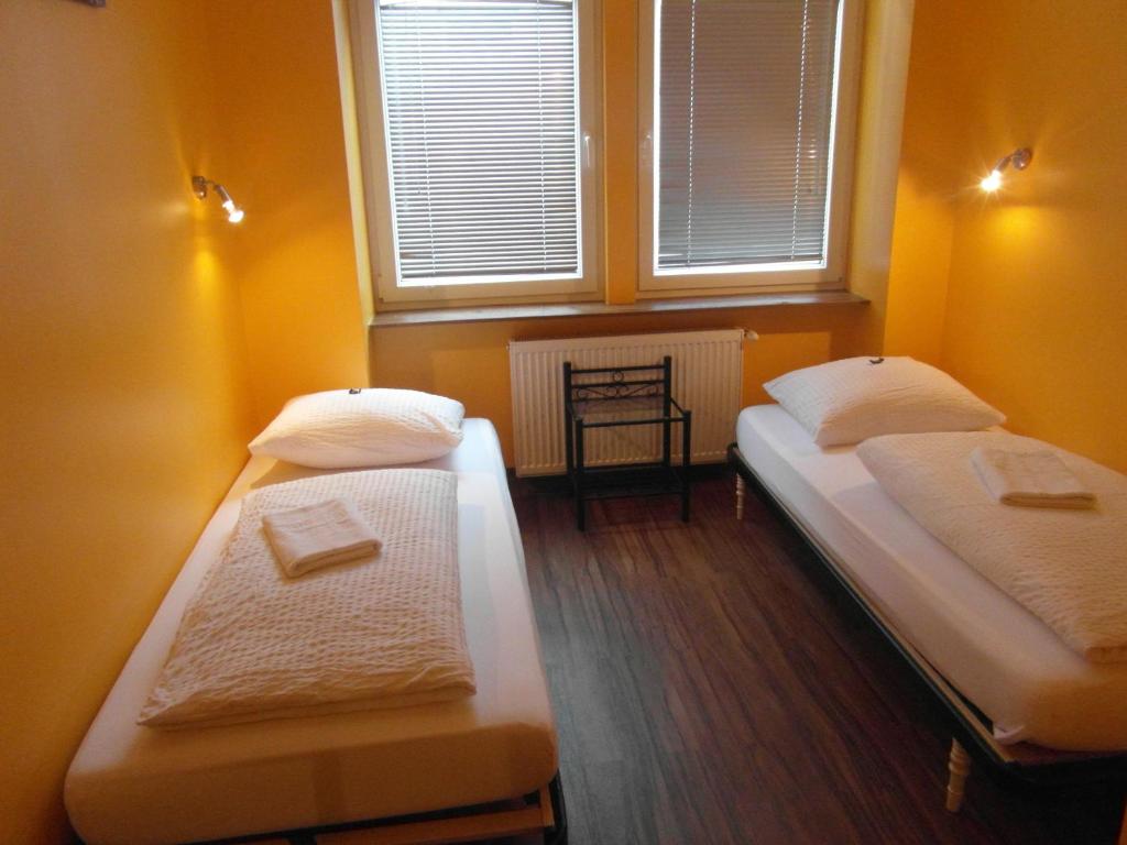 A bed or beds in a room at Do Step Inn Home - Hotel & Hostel