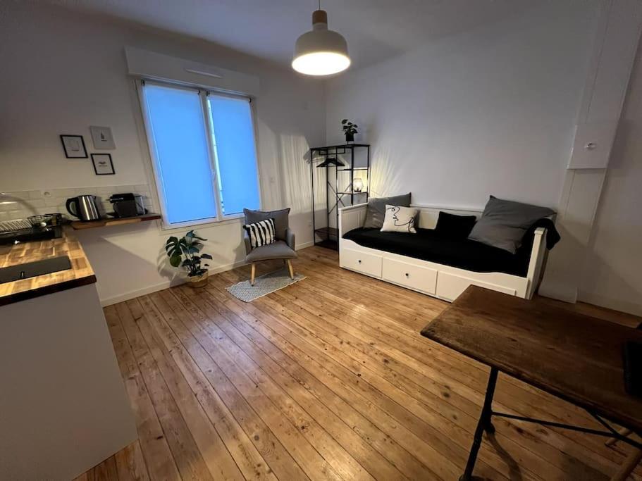 a living room with a couch and a table at Studio 3 - Mi-Côte - Studio à Orvault in Orvault