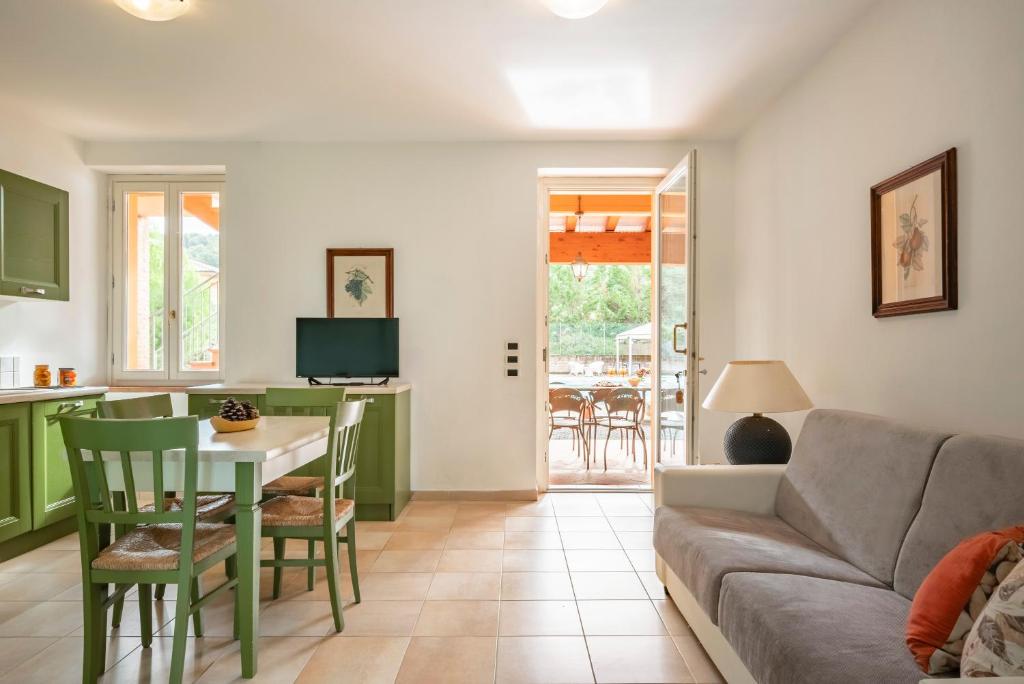 a living room with a couch and a table at Ombra Verde Residence e B&B in Follonica