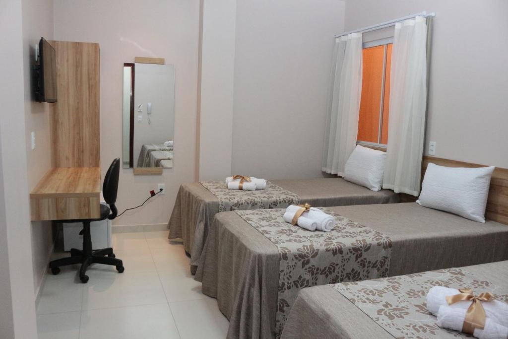 Postel nebo postele na pokoji v ubytování LC Palace Hotel