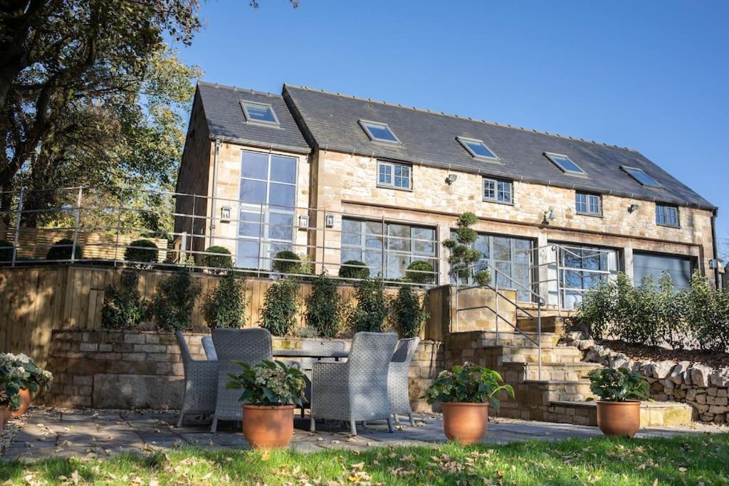 a house with two chairs in front of it at Lakeview Barn, sleeps 5-7 Guests new inside in Matlock