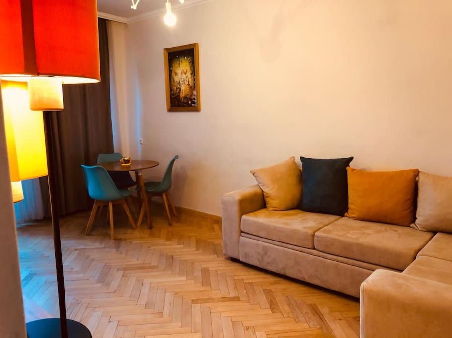 a living room with a couch and a table at Cozy flat in the middle of Tbilisi in Tbilisi City