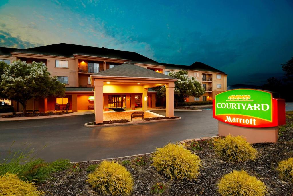 a hotel with a sign in front of a building at Courtyard by Marriott State College in State College