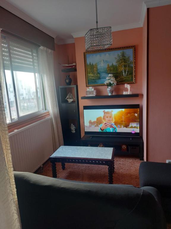 a living room with a tv and a couch and a table at Ría de vigo in Vigo