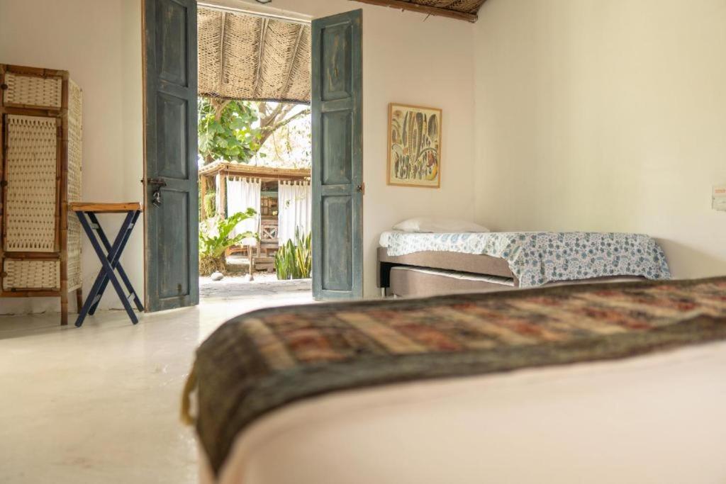 a bedroom with a bed and an open door at Ekaa Hotel in Palomino