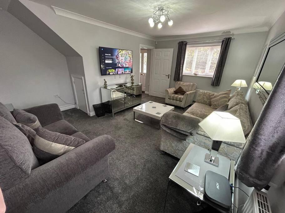 a living room with couches and a tv at Spacious House To Accommodate 6 in Willaston