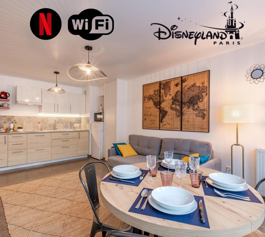 a dining room and kitchen with a table and chairs at Appartement Cosy très proche Disney in Coupvray