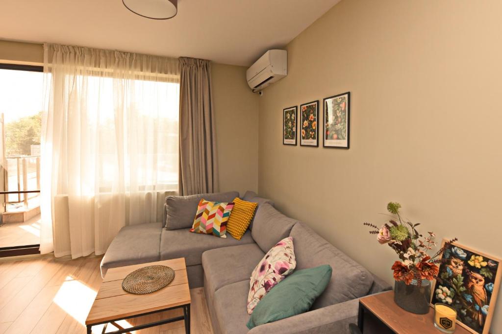 uma sala de estar com um sofá e uma mesa em Kalina Apartment Kazanlak em Kazanlŭk