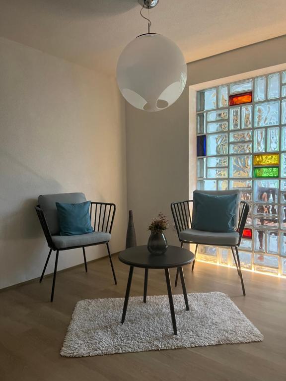 a living room with two chairs and a table at Panorama Appartements in Egg