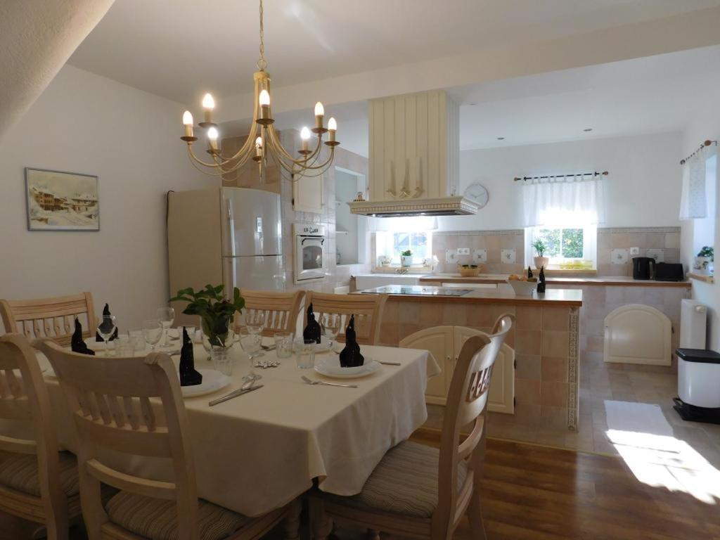 a kitchen and dining room with a table and chairs at Lea in Samobor