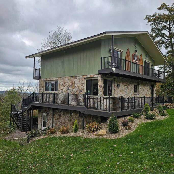a large house with a balcony on the side of it at Alpine Retreat @ Seven Springs! in Champion