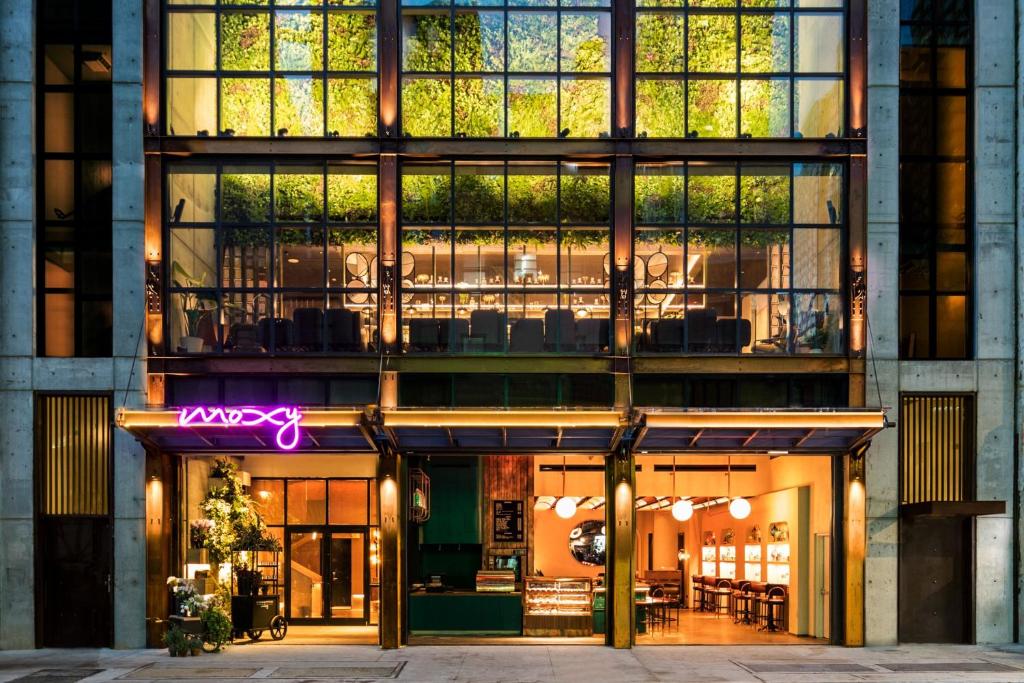 a facade of a building with a large window at Moxy NYC Chelsea in New York