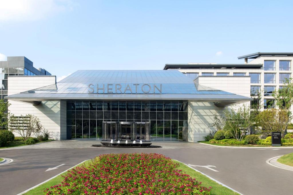 a building with a sign on the front of it at Sheraton Xuzhou in Xuzhou