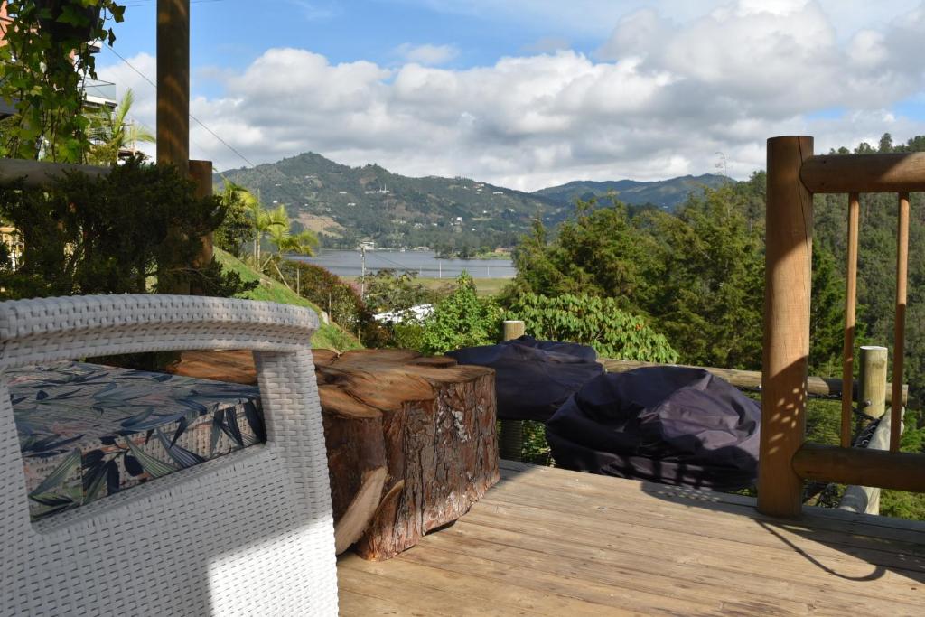 a wooden deck with a view of the mountains at EL PAISAJE MAS SOÑADO in El Retiro