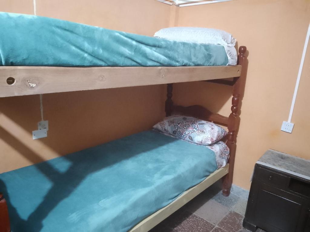 a couple of bunk beds in a room at Trinidad Hostal in San Salvador de Jujuy