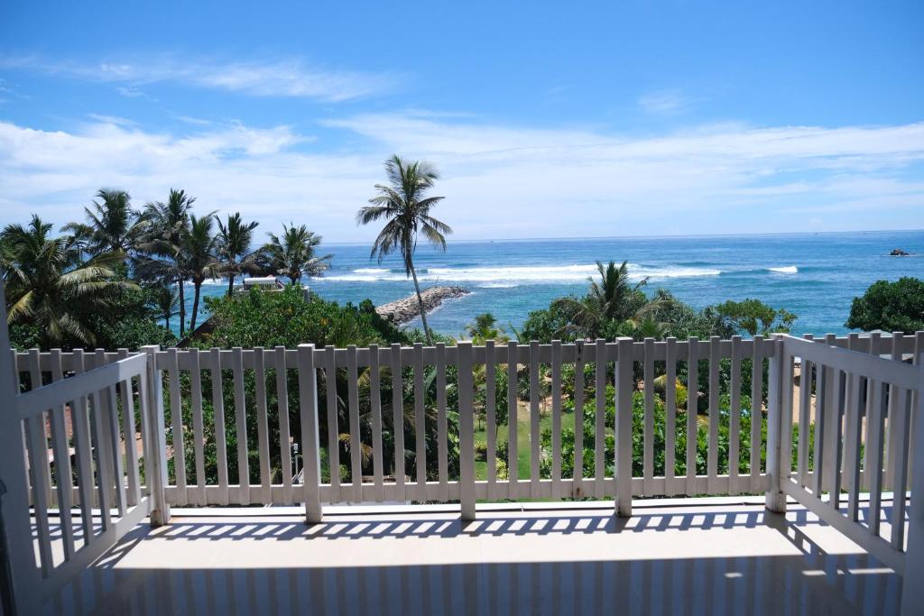 a balcony with a view of the ocean at BeachMirissa Hotel in Mirissa