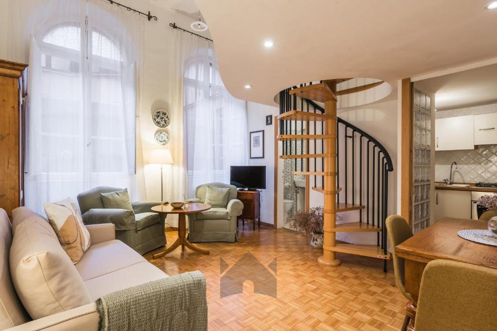 a living room with a couch and a spiral staircase at XXseptemberHome in Rome