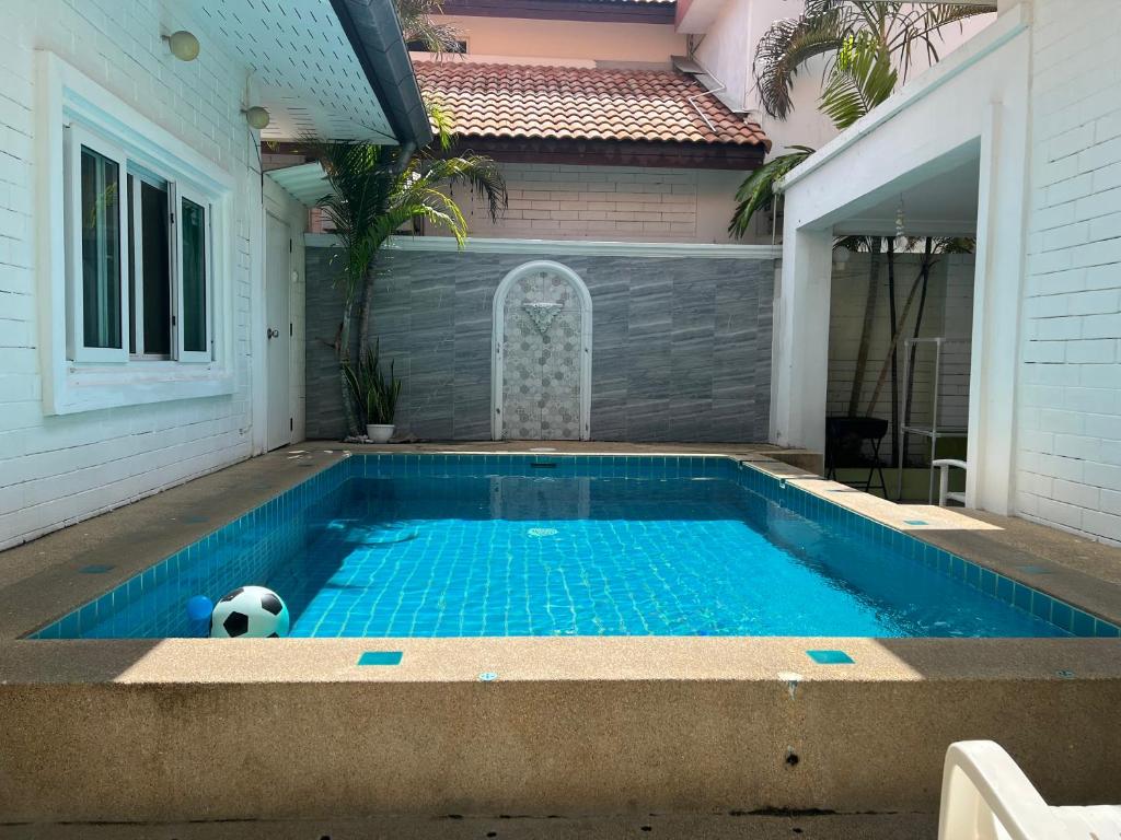 a soccer ball is sitting in a swimming pool at 芭提雅享受泳池别墅Enjoy Pool Villa in Pattaya South