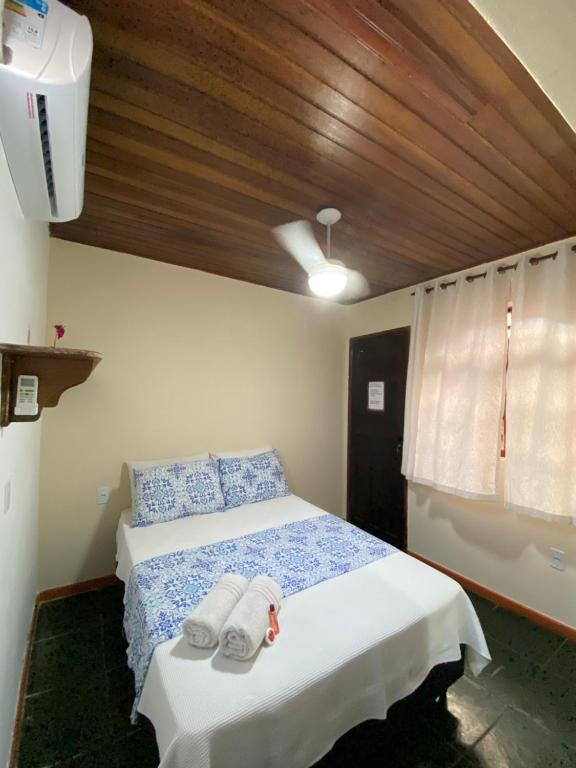 a bedroom with a bed with towels on it at Recanto da Bruna in Abraão