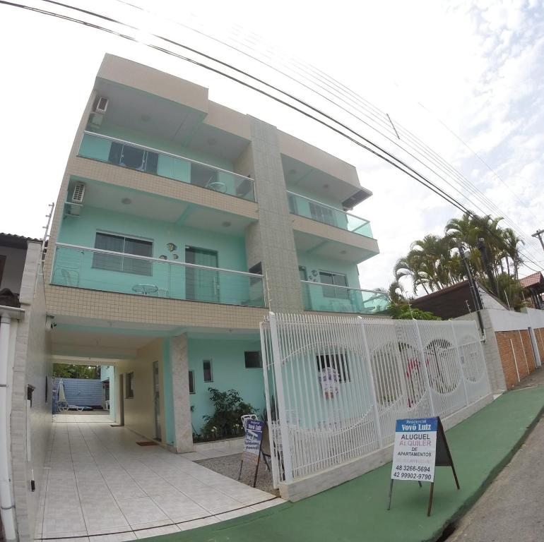 a building with a white fence in front of it at Residencial Vovó Luiz in Florianópolis