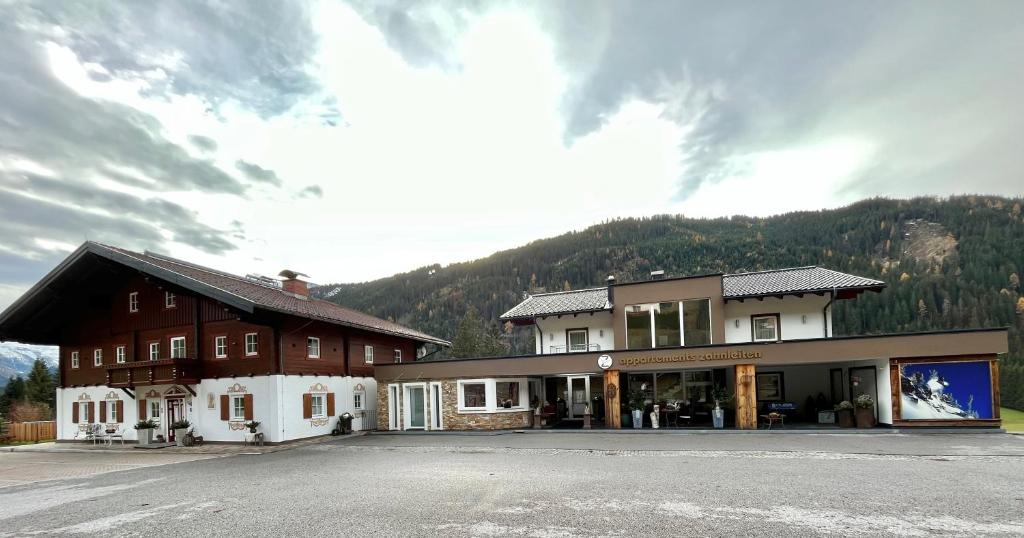 a building on the side of a road with a mountain at Appartements Zahnleiten in Untertauern