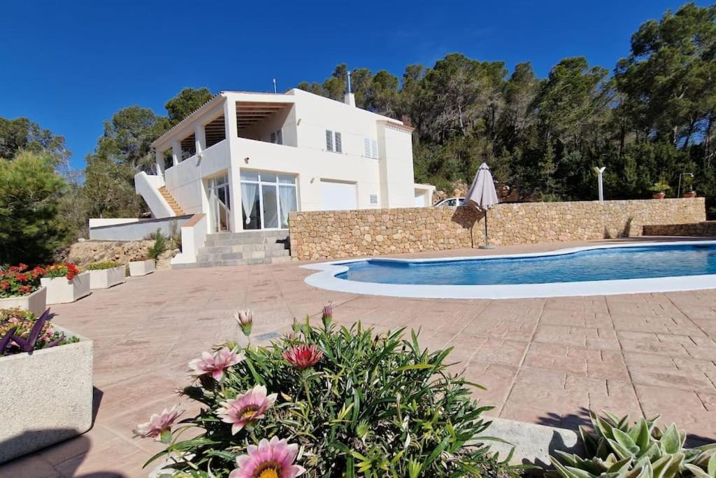 a villa with a swimming pool and a house at beautiful views with pool in ibiza in Sant Miquel de Balansat