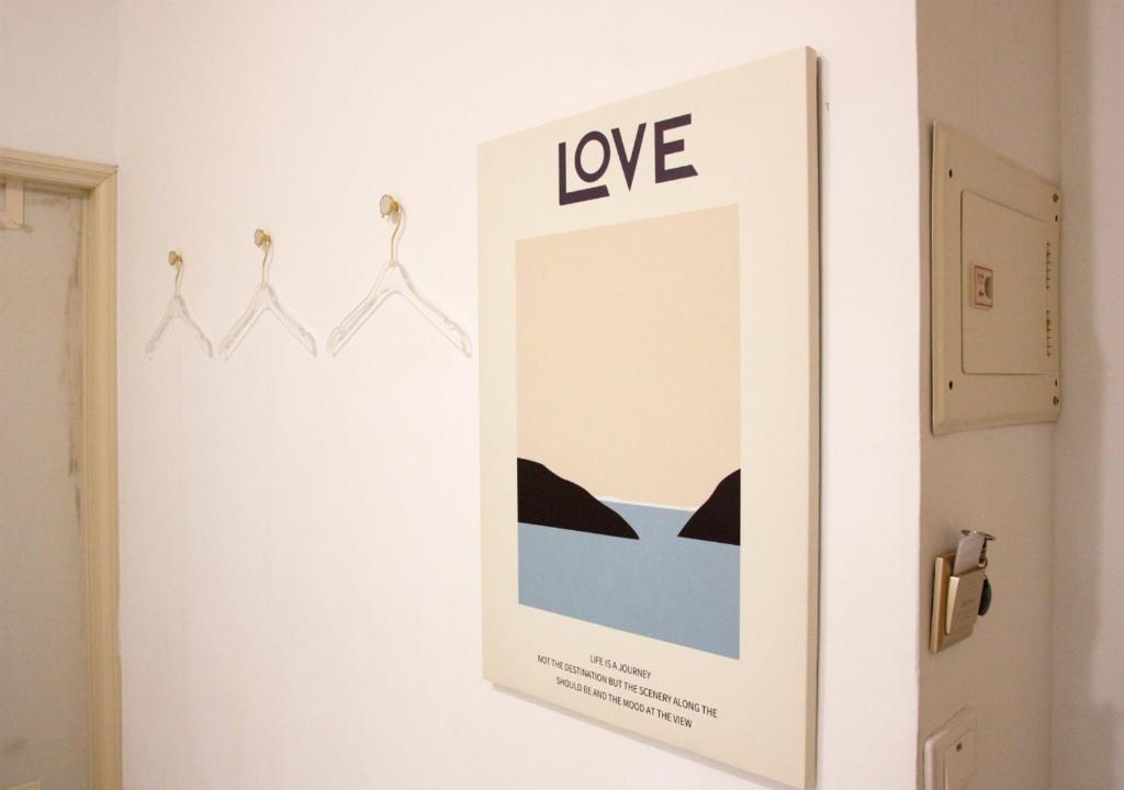 a mirror with the word love on a wall at 夕映安平 in Tainan