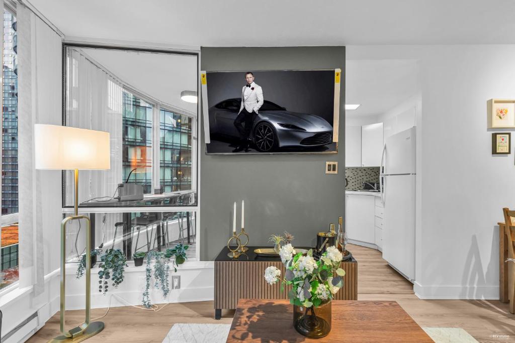a living room with a tv hanging on the wall at Chic 1BR Condo in Coal Harbour in Vancouver