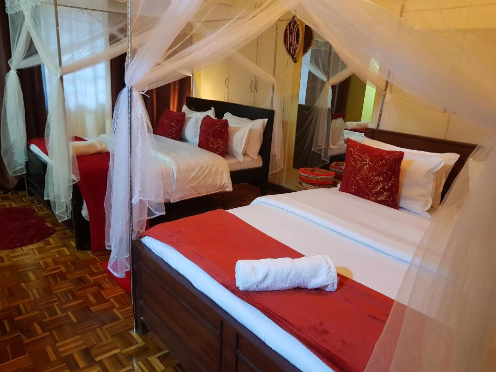 a bedroom with two beds in a room at Teresita Home in Nairobi