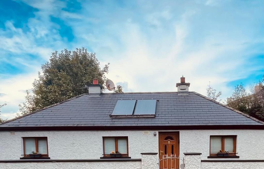 a house with two solar panels on the roof at River Cottage in Mullingar