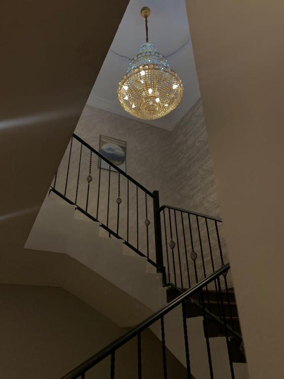 a staircase with a chandelier and a ceiling at شقة تنويه ليست للايجار in Al Khobar