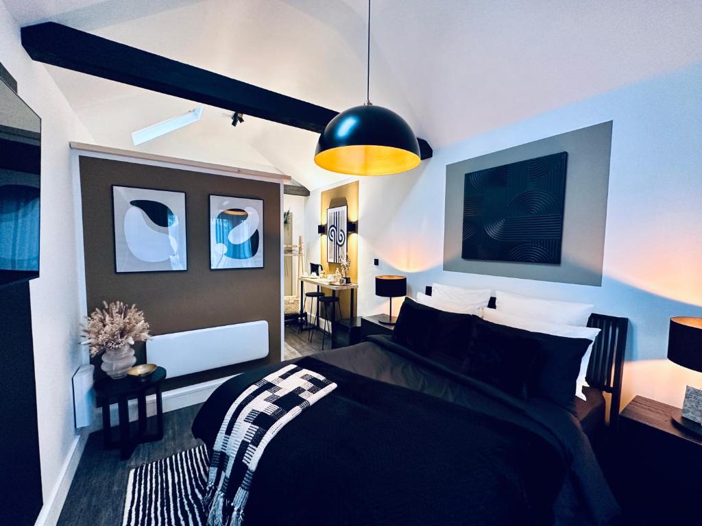 a bedroom with a black and white bed and a lamp at Luxury self-contained suite. in Cardiff