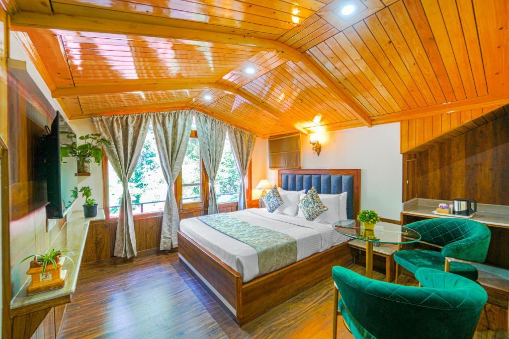 a bedroom with a bed and a table and chairs at Singhs BnB by Lazy Getaways in Shimla
