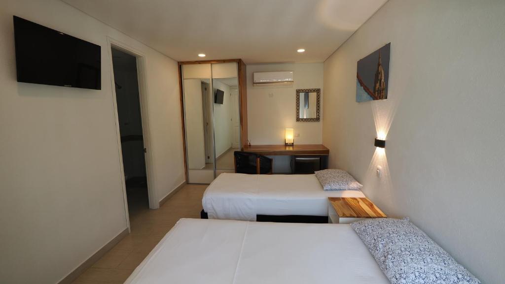 Postel nebo postele na pokoji v ubytování Hotel Casa Cytia