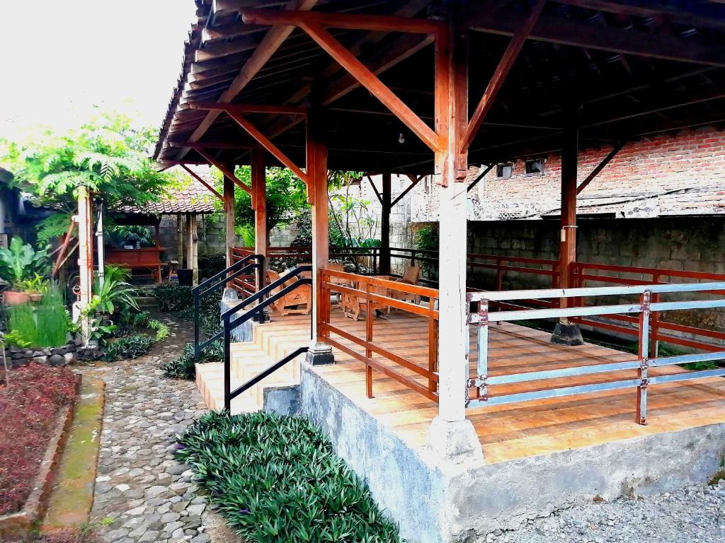 a porch of a building with a wooden deck at Semar88 Guest House in Balong