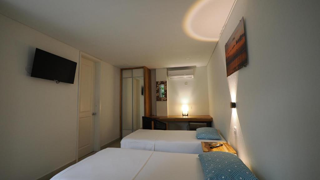 Postel nebo postele na pokoji v ubytování Hotel Casa Cytia
