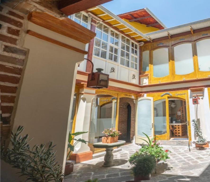 a building with a courtyard with plants and a fountain at Old Town Quito Suites, Heritage Boutique Hotel, Where Every Detail Tells a Story in Quito
