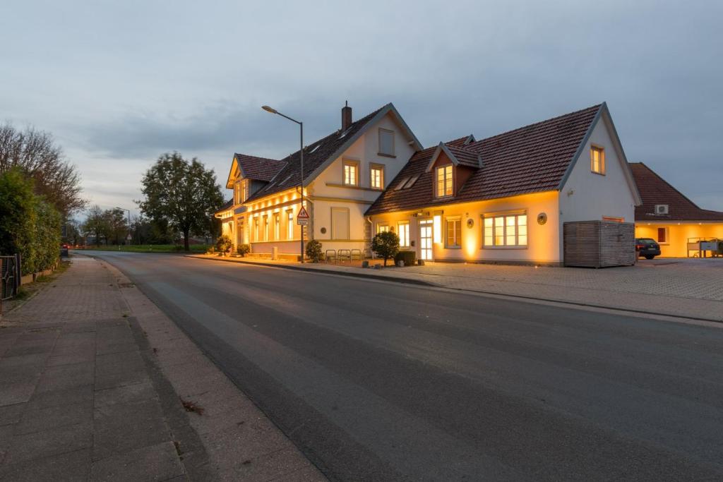 a house on a street with its lights on at Pension Sonne Appartements in Minden