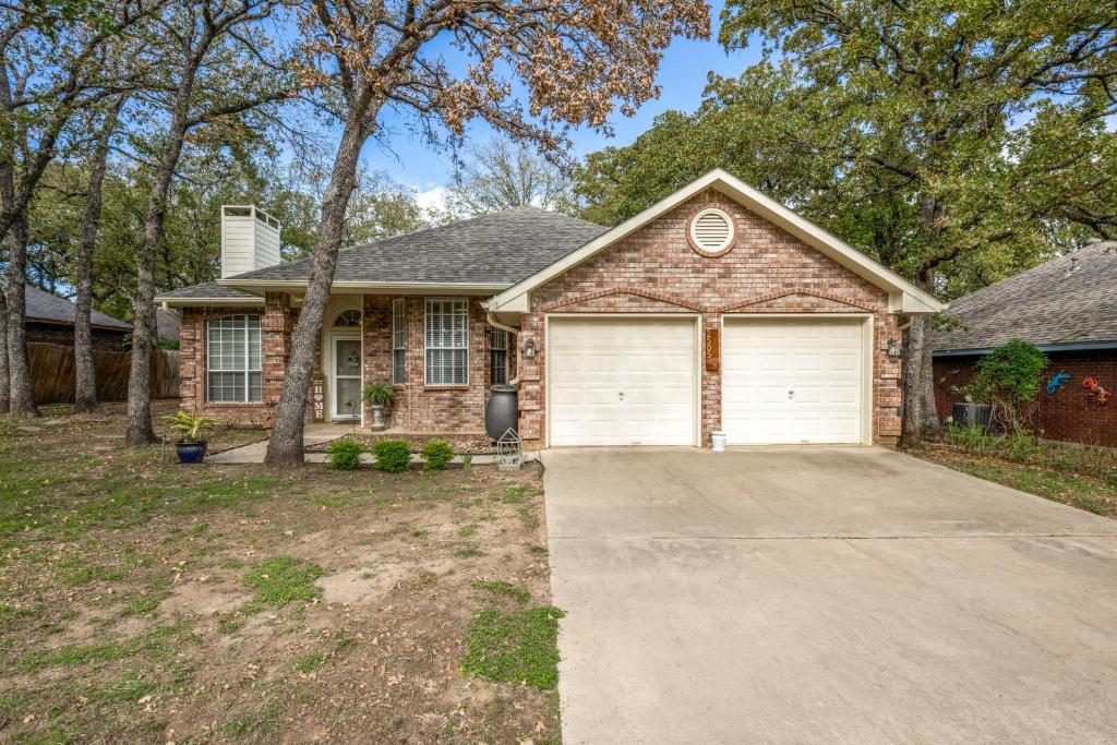 a brown brick house with a garage at Spacious Brick House 3BR 2BA A+ in Denton