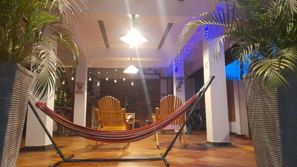 a hammock in a room with chairs and a table at Donama River in Palomino