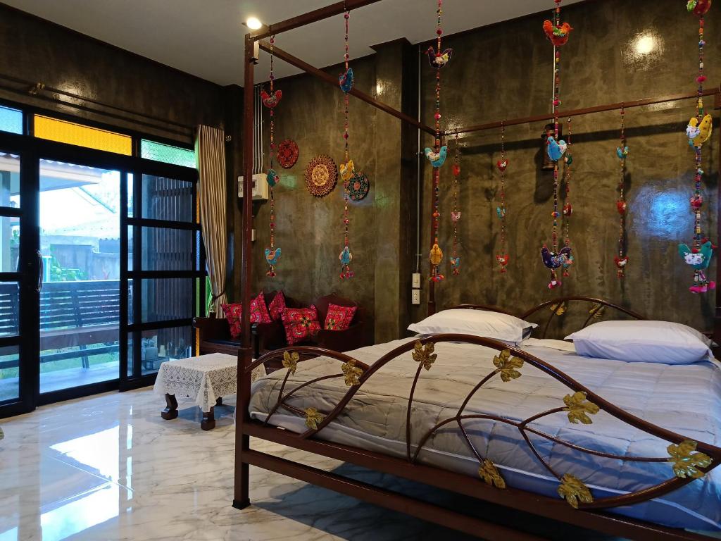 a bedroom with a bed with christmas ornaments on the wall at ต้นโพธิ์โฮมสเตย์ 