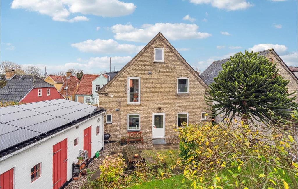 a brick house with red doors and a yard at Nice Apartment In Snderborg With Kitchen in Sønderborg