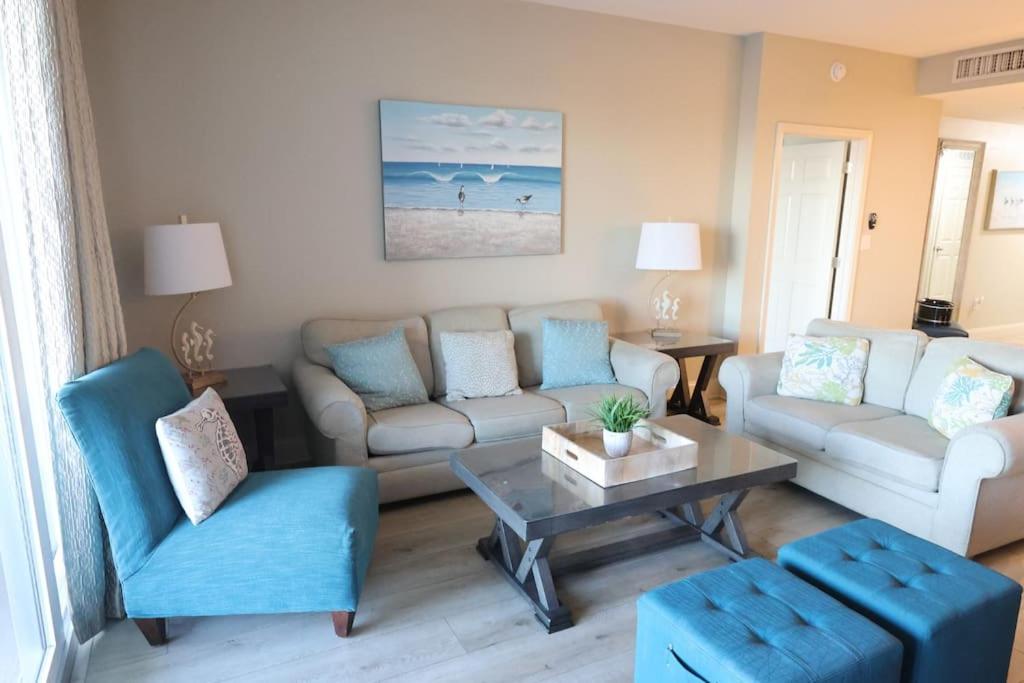 a living room with a couch and a table at Laketown Wharf 1233 luxury condo in Panama City Beach