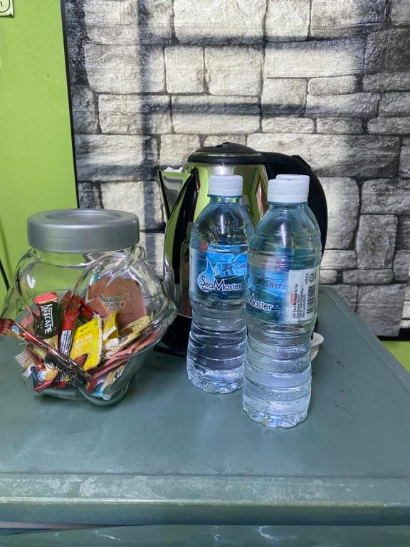 two bottles of water sitting on top of a table at LS ROMESTAY in Kangar