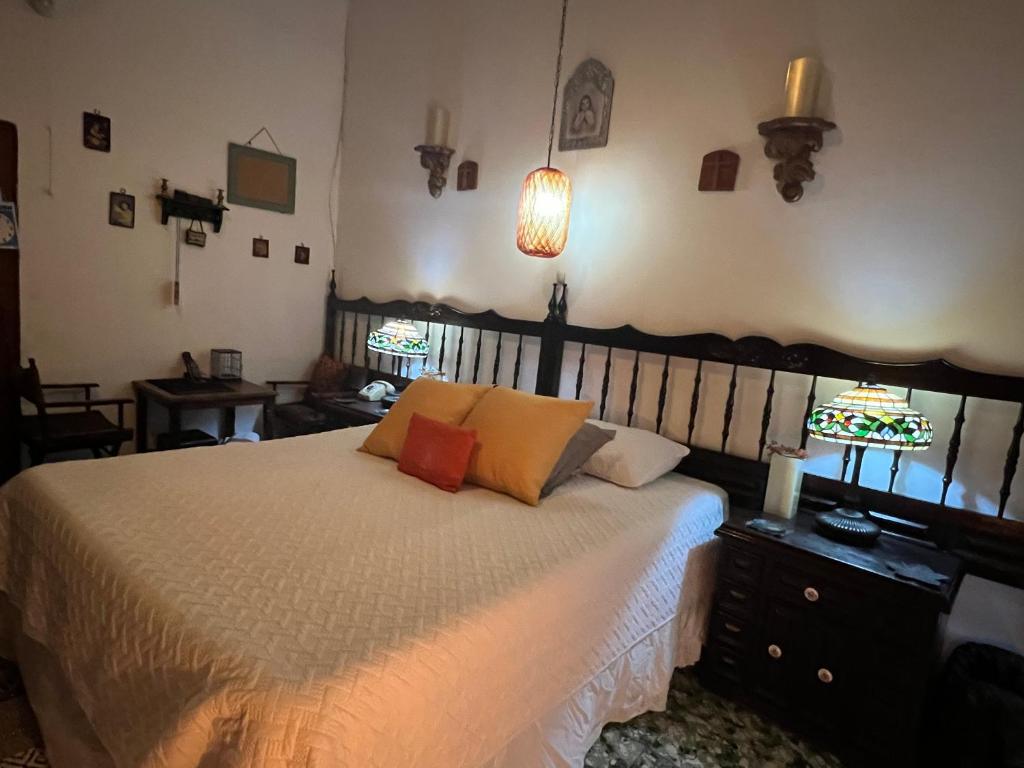 a bedroom with a bed with two pillows on it at Mendoza’s Guest House in Santa Ana