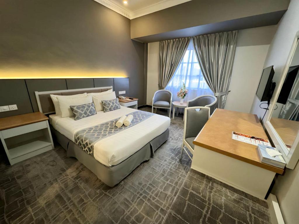 una camera d'albergo con letto e scrivania di Permai Hotel Kuala Terengganu a Kuala Terengganu