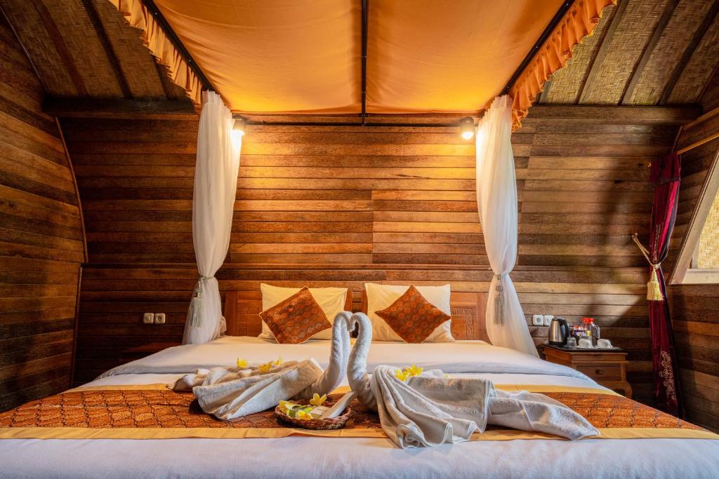 Postel nebo postele na pokoji v ubytování Bali Sesandan Garden