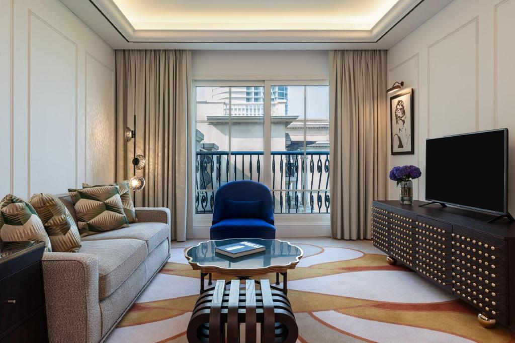a living room with a couch and a tv at The Westin Dubai Mina Seyahi Beach Resort and Waterpark in Dubai